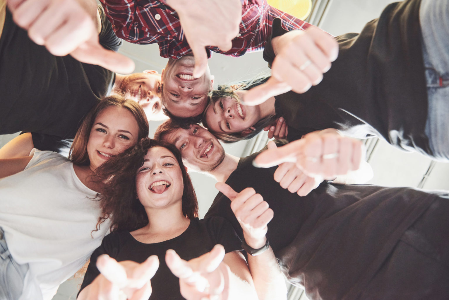 Happy Group Of Friends With Their Hands Together In The Middle Happy Group Of Friends With Their Hands Together In The Middle