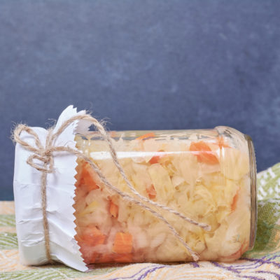 Sauerkraut In Glass Jar On Blue Background With Tablecloth Sauerkraut In Glass Jar On Blue Background With Tablecloth